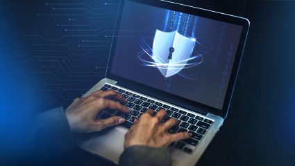 Closeup of hands working on computer keyboard Hacker cracking the security code on a laptop