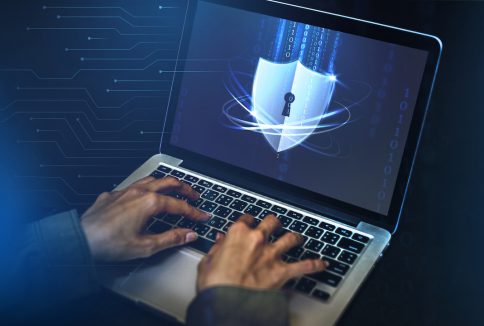 Hacker cracking the security code on a laptop